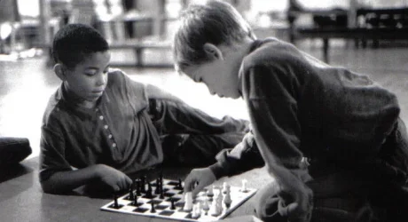 IT funders header image Two young boys concentrate while playing a game of chess, and black and white photo from the 1980's